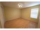 Bedroom with wood floors, closet, and a window with blinds at 2007 Country Brook Ave, Clermont, FL 34711
