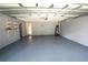 Spacious garage with painted floor, shelving and water heater at 2007 Country Brook Ave, Clermont, FL 34711