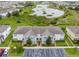 Aerial view of a condominium building next to a lake surrounded by lush green landscaping at 212 Primrose Dr, Davenport, FL 33837