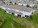 Aerial view of backyard, patio, and lawn of the townhome, set in a well-maintained community at 212 Primrose Dr, Davenport, FL 33837