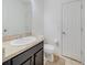 Cozy half bathroom with granite counters, undermount sink, and convenient toilet placement at 212 Primrose Dr, Davenport, FL 33837
