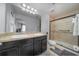 Spacious bathroom featuring dual sinks, a large mirror, and a walk-in shower with neutral tones at 212 Primrose Dr, Davenport, FL 33837
