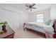 Serene bedroom with a ceiling fan, closet, and window offering ample natural light at 212 Primrose Dr, Davenport, FL 33837