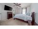 Inviting bedroom featuring a TV, large bed, ceiling fan, and soothing colors for relaxation at 212 Primrose Dr, Davenport, FL 33837