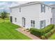 Attractive two-story home featuring lush green grass, a brick pathway, and colorful landscaping at 212 Primrose Dr, Davenport, FL 33837