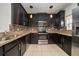 Stylish kitchen with dark wood cabinets, stainless steel appliances, and a tiled backsplash at 212 Primrose Dr, Davenport, FL 33837
