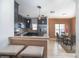 Modern kitchen with dark cabinets, stainless steel appliances, and a cozy dining area at 212 Primrose Dr, Davenport, FL 33837