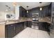 Modern kitchen featuring dark cabinets, stainless steel appliances, and a functional layout at 212 Primrose Dr, Davenport, FL 33837