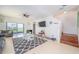 Bright living room with sliding glass doors to outside, tiled floors, and a staircase at 212 Primrose Dr, Davenport, FL 33837