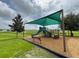 A colorful community playground with a slide and sunshade at 212 Primrose Dr, Davenport, FL 33837