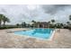 Resort-style pool with a covered lounge area and brick paver patio at 212 Primrose Dr, Davenport, FL 33837