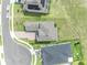 An aerial view showcasing the home's roof, brick paved driveway, landscaping and proximity to the cul-de-sac at 2147 Timber Creek Ln, Clermont, FL 34715