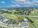 A beautiful aerial view of a modern home featuring a brick paved driveway, manicured landscaping and surrounding landscape at 2147 Timber Creek Ln, Clermont, FL 34715