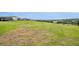 Expansive backyard view overlooking the rolling green hills in a serene neighborhood setting at 2147 Timber Creek Ln, Clermont, FL 34715
