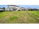 A spacious backyard featuring lush green grass, new construction homes, and mature landscaping at 2147 Timber Creek Ln, Clermont, FL 34715