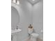 Elegant half-bathroom features a sleek pedestal sink, modern toilet, and stylish design at 2147 Timber Creek Ln, Clermont, FL 34715