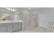 Bathroom features a glass-enclosed shower, a soaking tub, and dual vanities with modern fixtures at 2147 Timber Creek Ln, Clermont, FL 34715