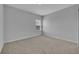 A cozy bedroom features neutral carpeting, light gray walls, and a bright window at 2147 Timber Creek Ln, Clermont, FL 34715