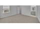 A spacious bedroom with neutral carpet and an open doorway to an en suite bathroom featuring a gray vanity at 2147 Timber Creek Ln, Clermont, FL 34715