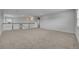 Large bonus room with neutral walls, carpet and a staircase with white banisters and dark wood trim, illuminated by recessed lighting at 2147 Timber Creek Ln, Clermont, FL 34715