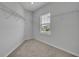 Walk-in closet with neutral walls, carpet, a window and wire shelving on three sides at 2147 Timber Creek Ln, Clermont, FL 34715
