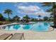 Resort-style community pool with ample lounge seating and lush tropical landscaping for ultimate relaxation at 2147 Timber Creek Ln, Clermont, FL 34715