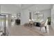 Open dining area with white table and chairs, chandelier, view to living area, and tile floors at 2147 Timber Creek Ln, Clermont, FL 34715