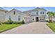 Stunning two-story home with brick driveway, attached two-car garage and meticulously maintained landscaping at 2147 Timber Creek Ln, Clermont, FL 34715