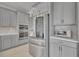 Contemporary kitchen with gray cabinets, stainless steel appliances, and modern backsplash at 2147 Timber Creek Ln, Clermont, FL 34715