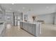 Large kitchen island with stainless steel appliances and modern gray cabinets at 2147 Timber Creek Ln, Clermont, FL 34715