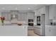 Modern kitchen featuring stainless steel appliances, quartz countertops, and ample cabinet space at 2147 Timber Creek Ln, Clermont, FL 34715