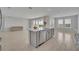 Expansive kitchen with island and large windows and open concept to living room at 2147 Timber Creek Ln, Clermont, FL 34715