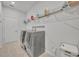 This laundry room features new washer and dryer units and plenty of storage shelves at 2147 Timber Creek Ln, Clermont, FL 34715