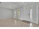 Bright living room with white walls, light-colored tile flooring, and view to the outside at 2147 Timber Creek Ln, Clermont, FL 34715