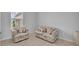 Comfortable living room with patterned sofas and natural light from the window at 2147 Timber Creek Ln, Clermont, FL 34715