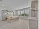 Spacious main bedroom features plush carpeting, light walls, and bright windows overlooking the yard at 2147 Timber Creek Ln, Clermont, FL 34715