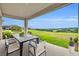 Covered patio features outdoor dining with stunning views of green rolling hills in the distance at 2147 Timber Creek Ln, Clermont, FL 34715
