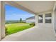 An expansive patio with a scenic view of a rolling green hillside and distant neighborhood homes at 2147 Timber Creek Ln, Clermont, FL 34715