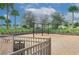 A lovely community playground with swings and safe play area surrounded by lush tropical landscaping and palm trees at 2147 Timber Creek Ln, Clermont, FL 34715