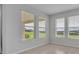 Bright room featuring three large windows with scenic views at 2147 Timber Creek Ln, Clermont, FL 34715
