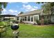 Enjoy outdoor living in this spacious backyard with patio furniture and a grill, perfect for entertaining guests at 215 Chula Vista Ave, The Villages, FL 32159