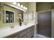 Bathroom features a double sink vanity, large mirror, and walk-in shower at 215 Chula Vista Ave, The Villages, FL 32159
