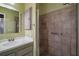 Bathroom showing a single sink vanity with a tiled shower at 215 Chula Vista Ave, The Villages, FL 32159