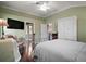 A spacious bedroom with a large bed, ensuite bathroom, wardrobe and a television at 215 Chula Vista Ave, The Villages, FL 32159