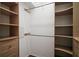 Walk-in closet with wooden shelves, drawers, and hanging rods offer ample storage at 215 Chula Vista Ave, The Villages, FL 32159