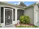 Inviting front entrance with decorative screen door and lush landscaping at 215 Chula Vista Ave, The Villages, FL 32159