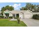 Charming single-story home with well-manicured lawn, two-car garage, and inviting entrance at 215 Chula Vista Ave, The Villages, FL 32159
