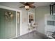 Cozy screened front porch with ceiling fan and seating area at 215 Chula Vista Ave, The Villages, FL 32159