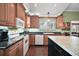 Open kitchen with modern appliances, granite countertops and lots of cabinets at 215 Chula Vista Ave, The Villages, FL 32159