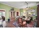Comfortable living room with hardwood floors, a decorative cabinet, and a large decorative mirror at 215 Chula Vista Ave, The Villages, FL 32159